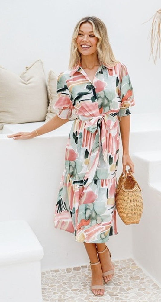 Satiny feel shirt dress with buttons and a tie waist. featuring a bright tropical theme pattern of greens and pinks